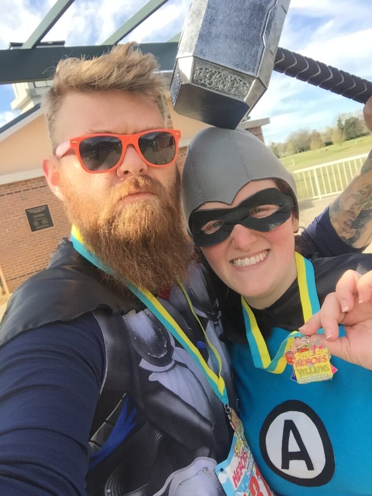 Two runners dressed as superheroes