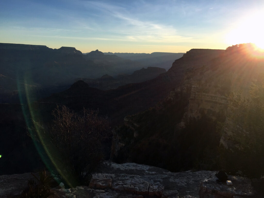 Sun peaking over Grand Canyon