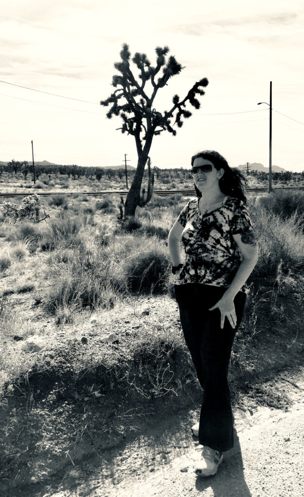 girl standing next to a joshua tree