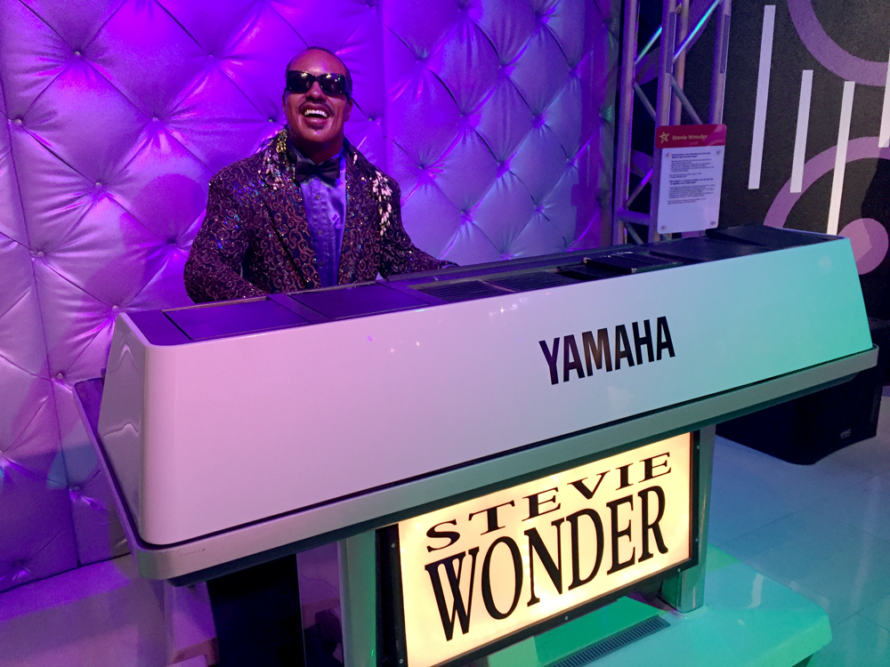 Wax figure of Stevie Wonder at a piano